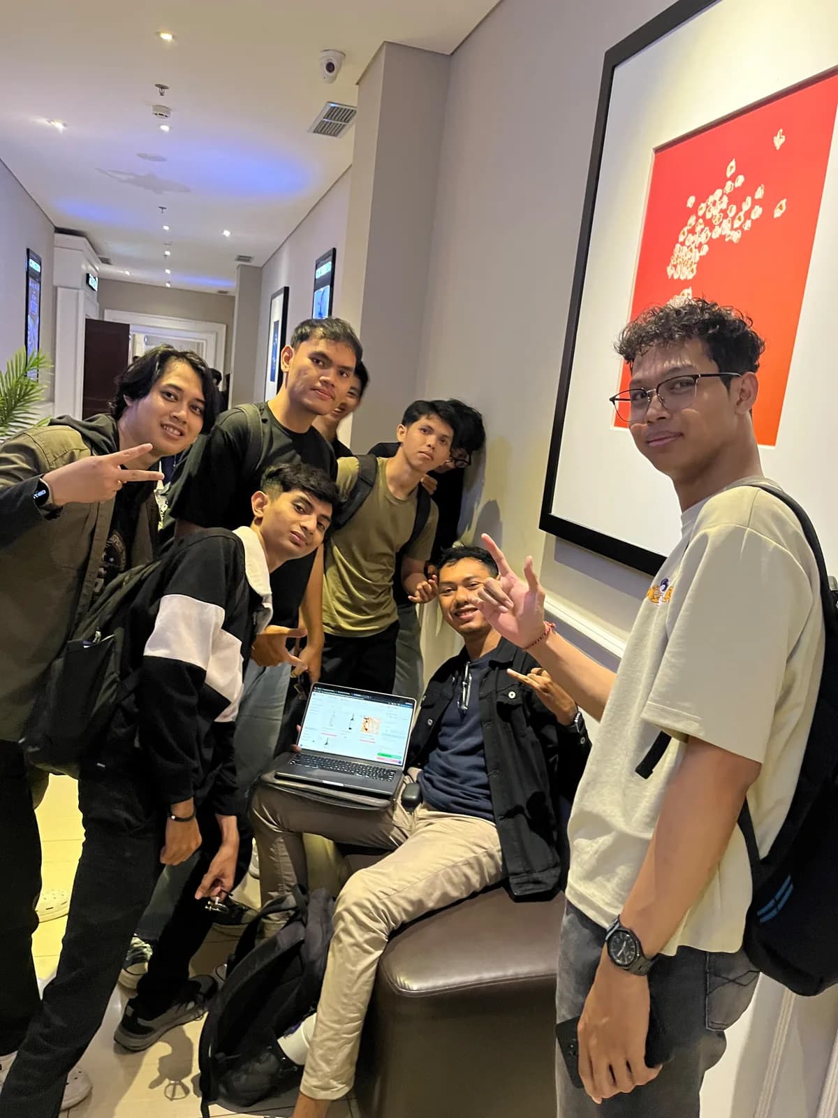 The Wine Adore dev team gathered around a laptop in the office